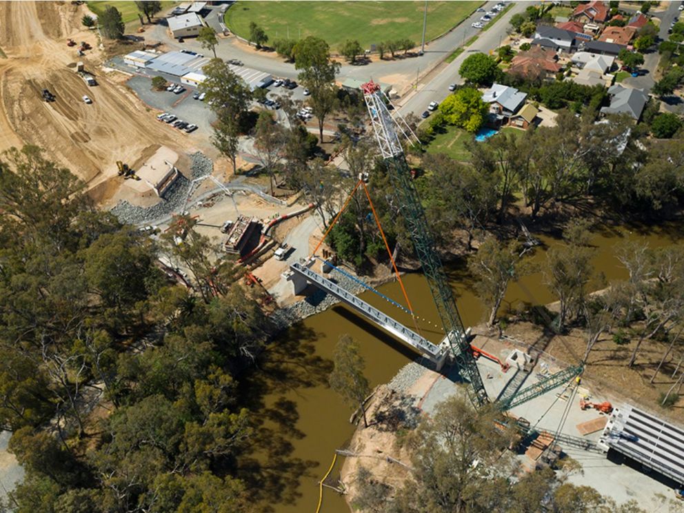 Birds eye image of a steel beam being lifted in place for the Campaspe River bridge