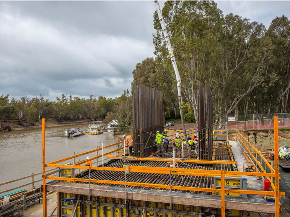 Image of the pier forming process with construction workers assisting