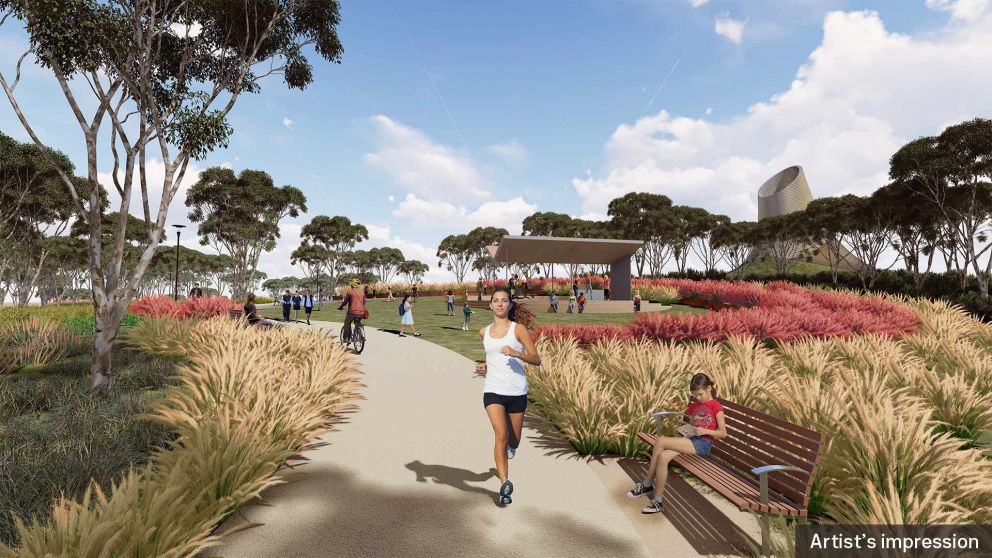 An artist impression ground level view of recreational park users on the Yarra Link green bridge and showing the southern portal ventilation structure in the background.