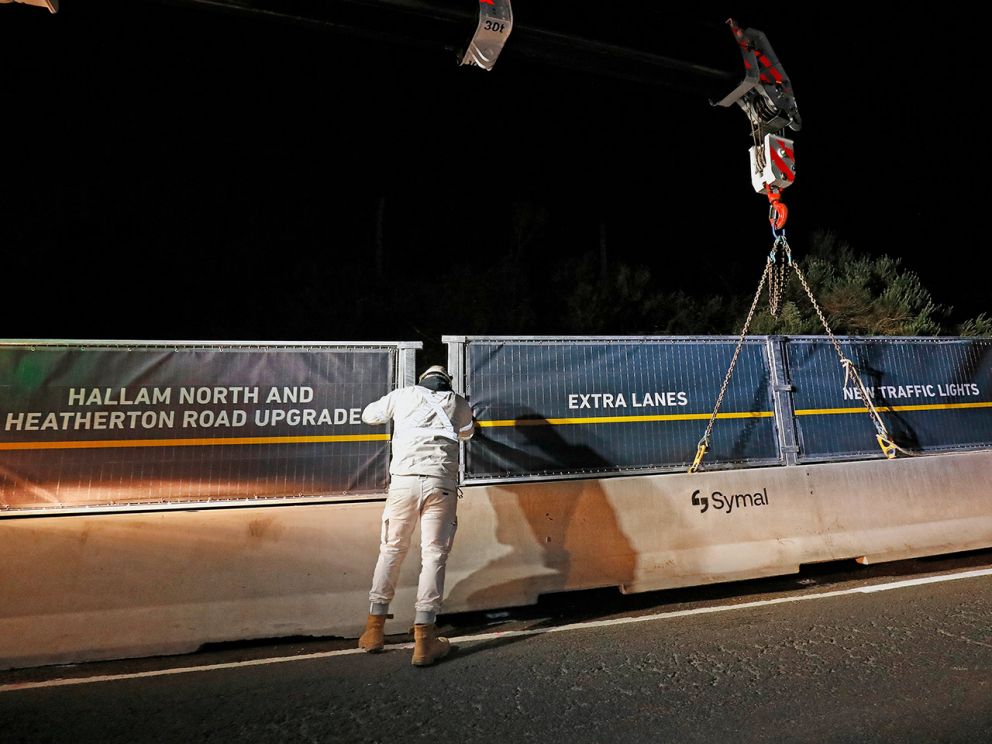 Safety barrier being lifted into place