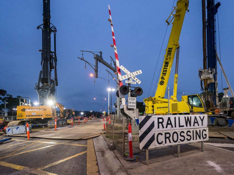 Two piling rigs at the level crossing.