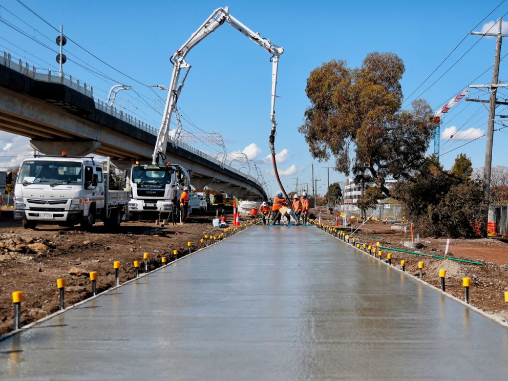 Wet concrete on the ground to create a bike path.