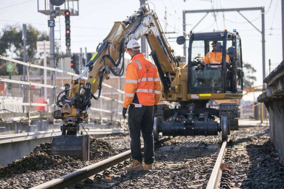 Hi-rail excavator moves ballast at Glenhuntly Station to perform critical works