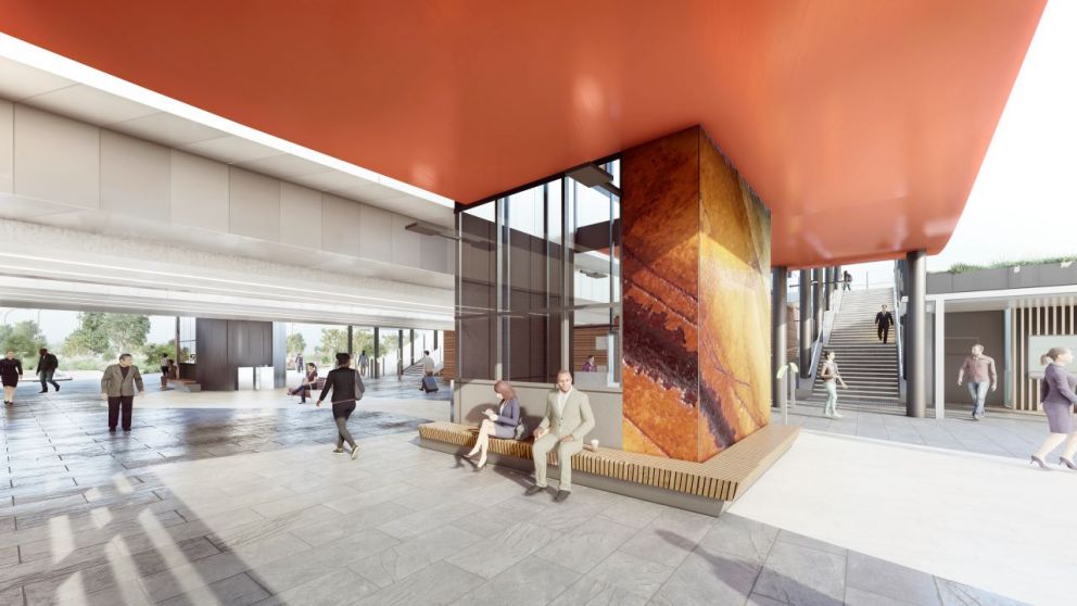 Artist's render of the new lift shaft and seating area in the Deer Park Station building. The lift shaft features a orange and brown pattern, and the ceiling is a bright red orange colour. There is wooden seating bordering the lift shaft where people sit.