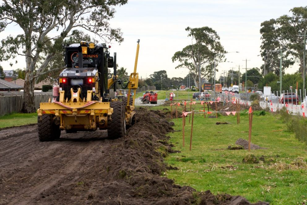 Grading the south side of Hall Road near Edinburgh Drive for construction vehicle access into work areas