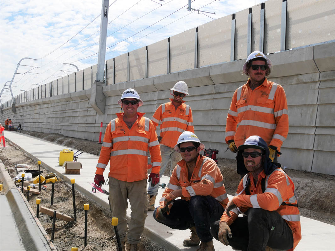 Workers standing on path under construction