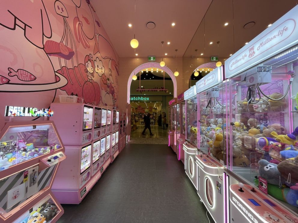Inside an arcade store, claw machines are lined up