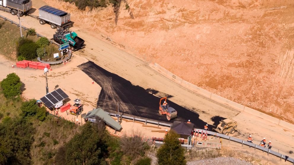 Crews asphalt a section of Bogong High Plains Road beside the landslip 05 April