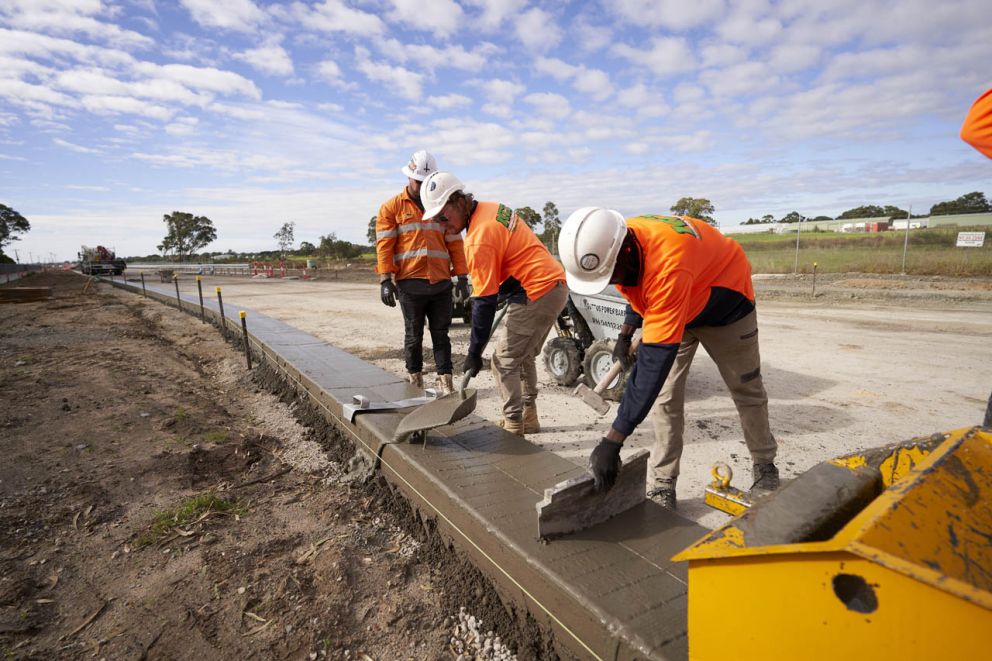 Many hands making light work of freshly laid kerb along Hall Road at Taylors Road