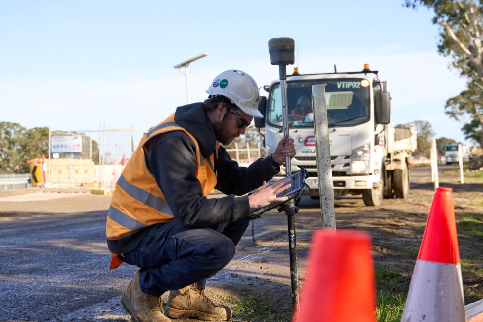 A skilled surveyor marking out levels and gathering the critical data that ensures Hall Road is built just right