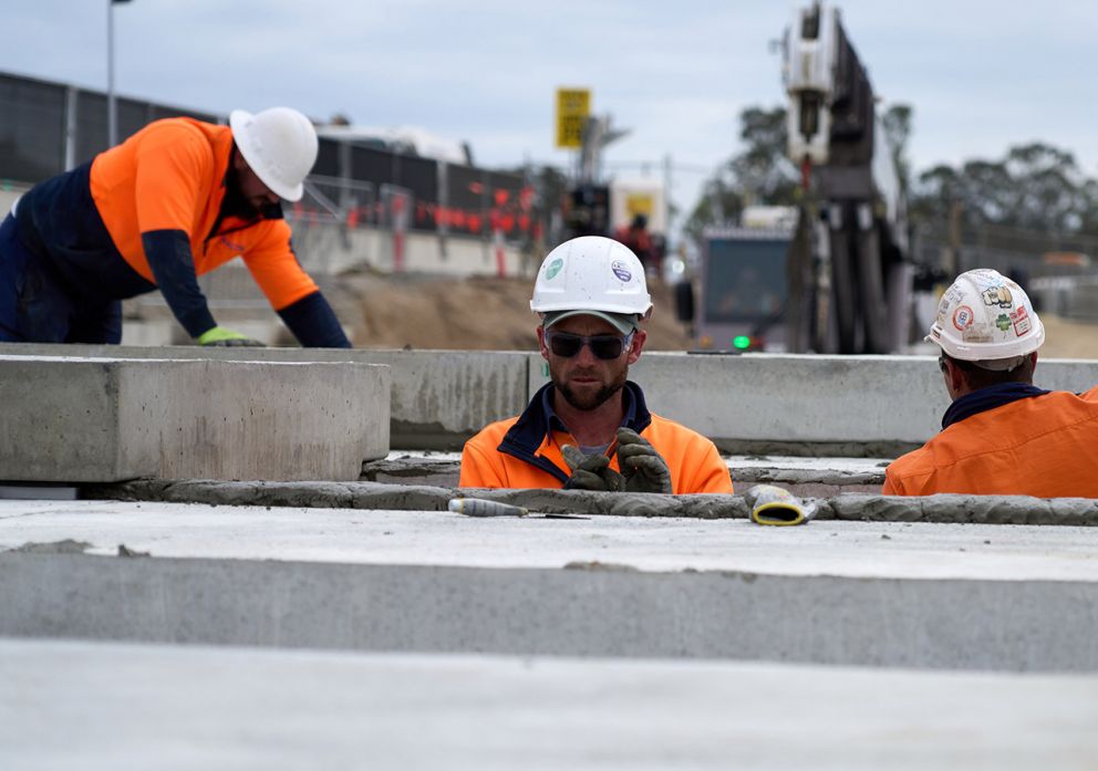 Crews hard at work installing drainage on the largest concrete slab of the project