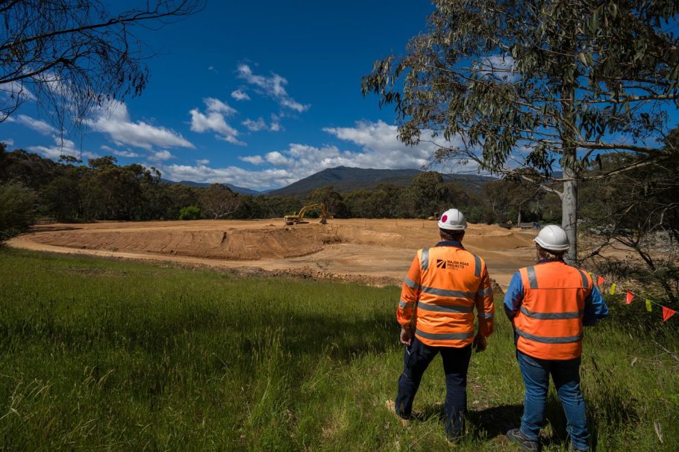 Two crew members looking across Wermatong Pit