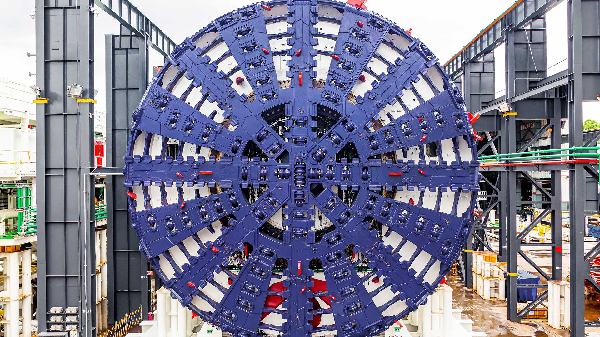 Photo of a very large, purple coloured tunnel boring machine cutterhead.