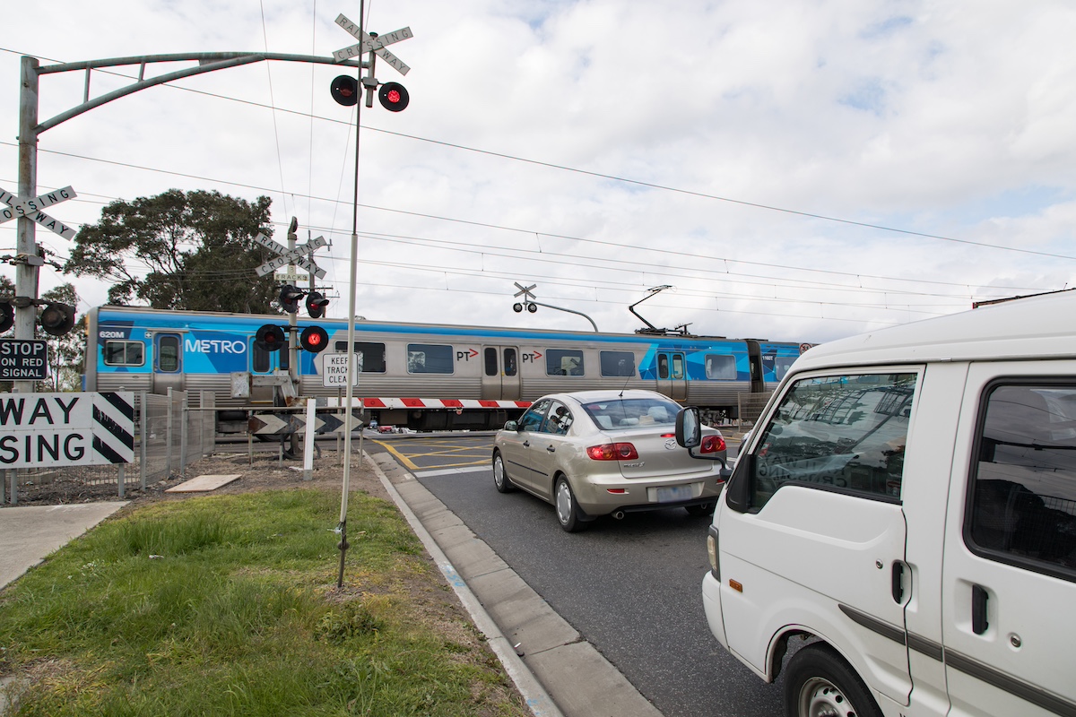 A train passing through the level crossing at Webster Street, Dandenong