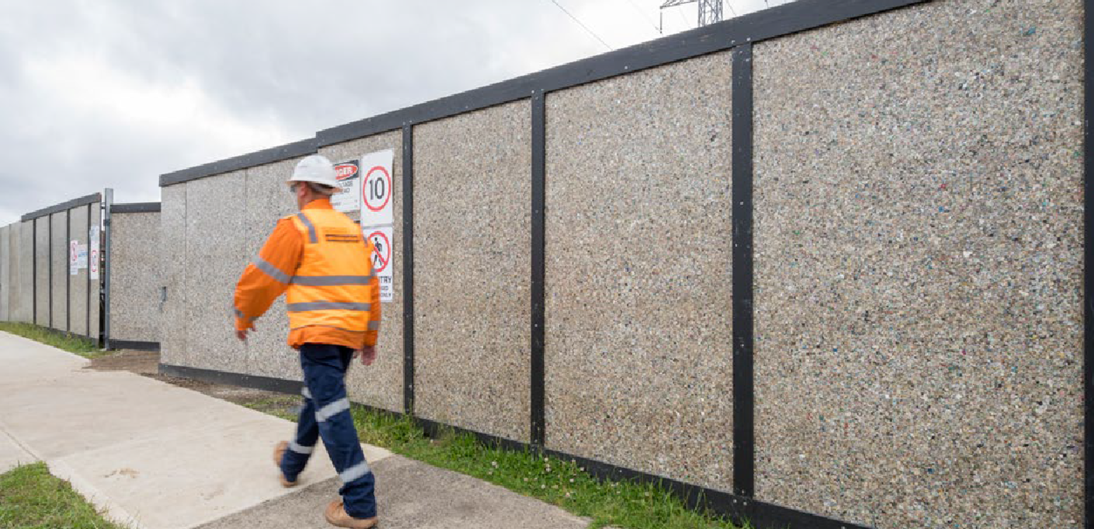 Hoarding made from recycled cardboard and plastic, including coffee cups