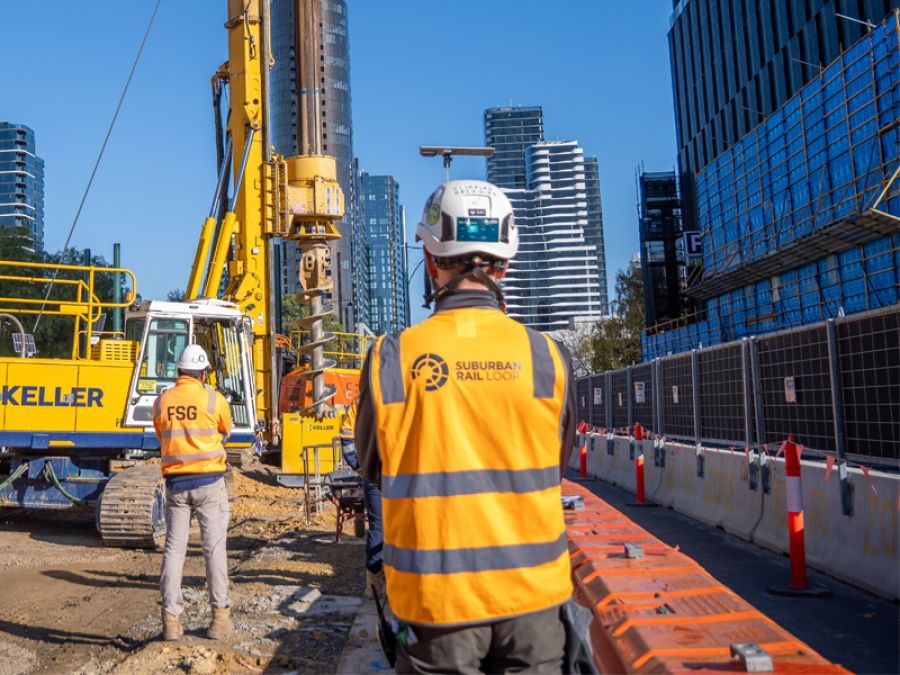 Construction worker observing worksite machinery in Box Hill