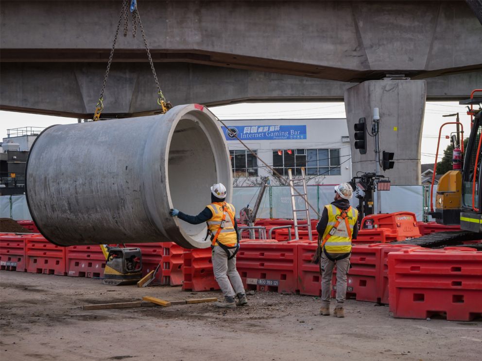 Truck and crew onsite installing water pipe on Clayton Road.