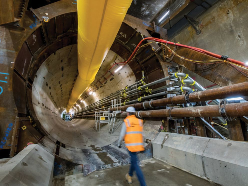 Crew member walking into tunnel entrance point