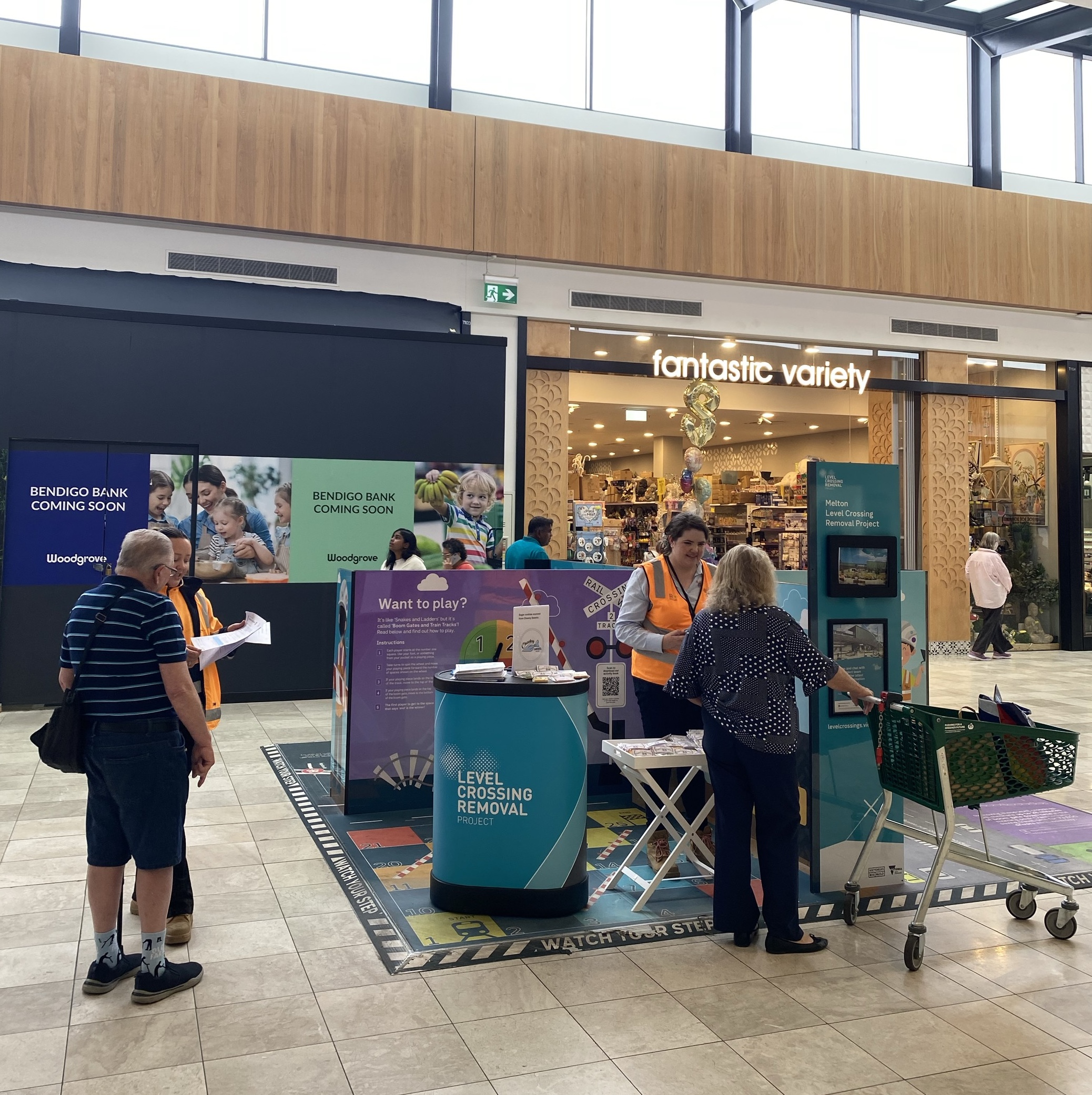 Group of people talking to LXRP staff at the Melton information booth
