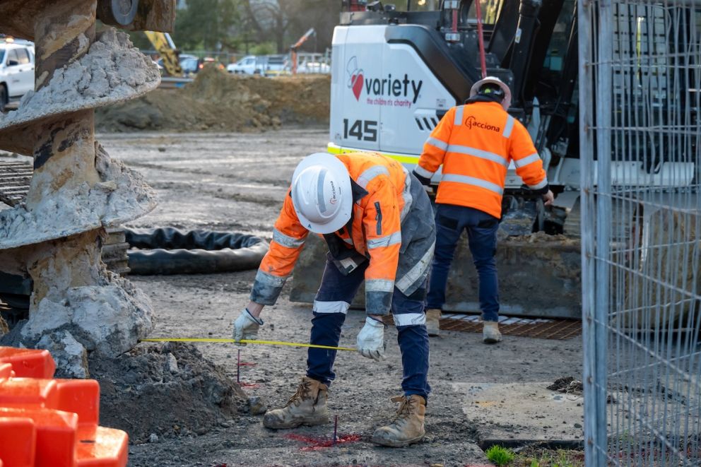 Worker checks the accuracy of piling works for the Webster Street level crossing removal