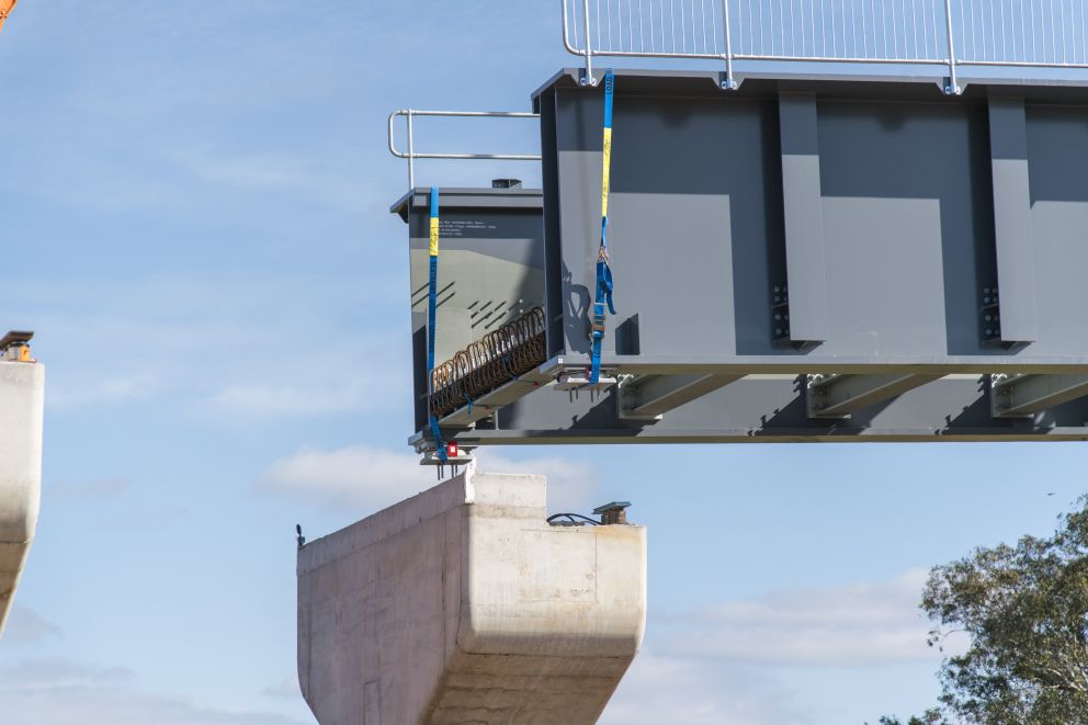 Crews carefully lifted in the steel bridge structures to connect the rail bridge over Coburns Road