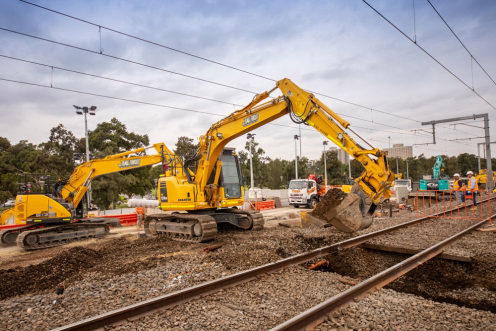 Excavators dig below the tracks in Kensington during a rail occupation