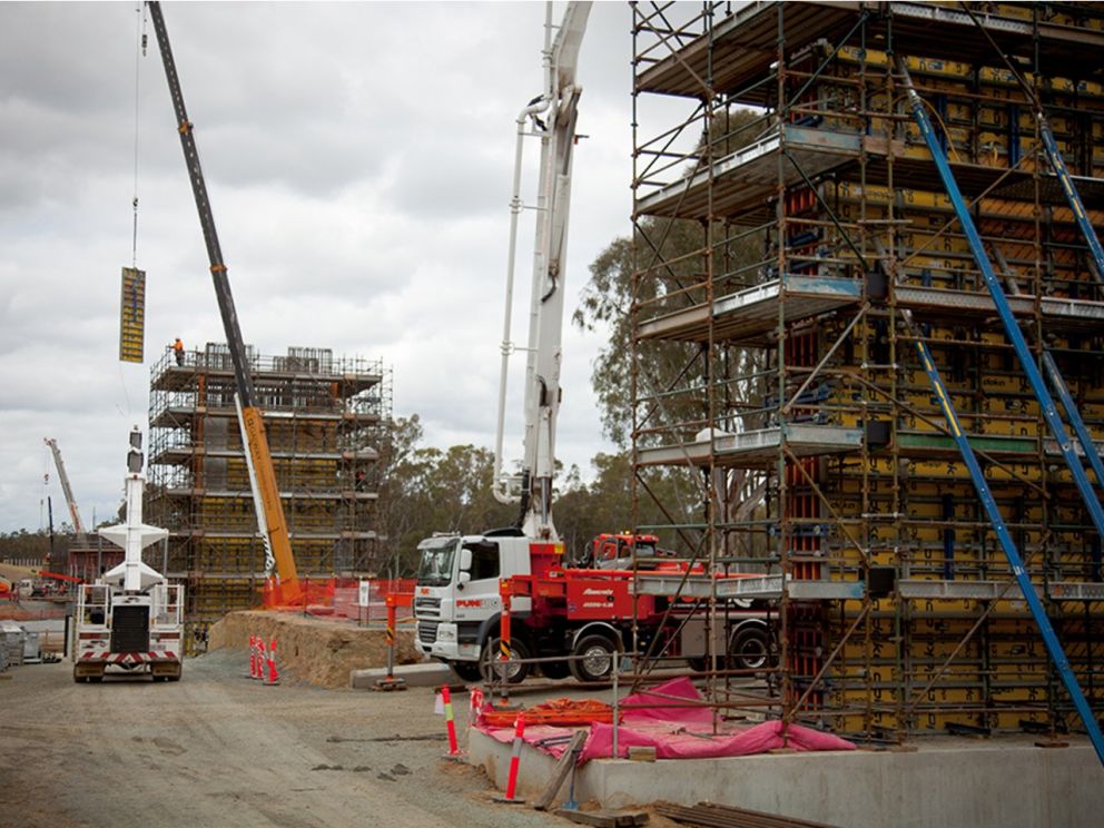 Image of the Murray River bridge piers being built with trucks and cranes within the image.