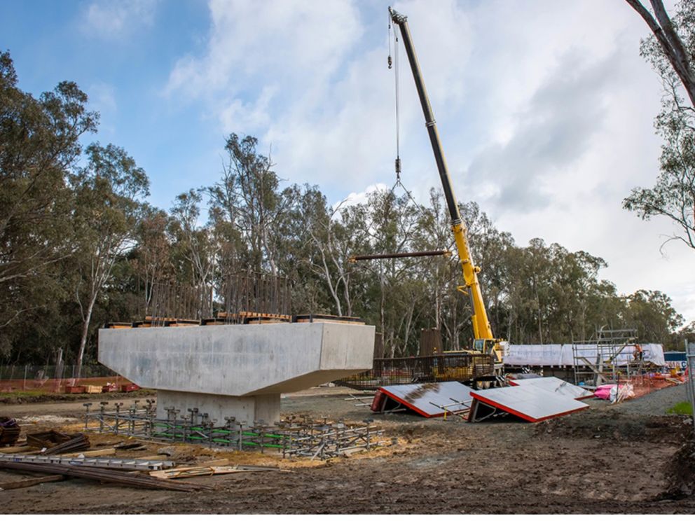 Stage 3 bridge pier construction with a crane in the image