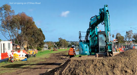 Soil stripping on the Monash Freeway. A digger lifting soil.