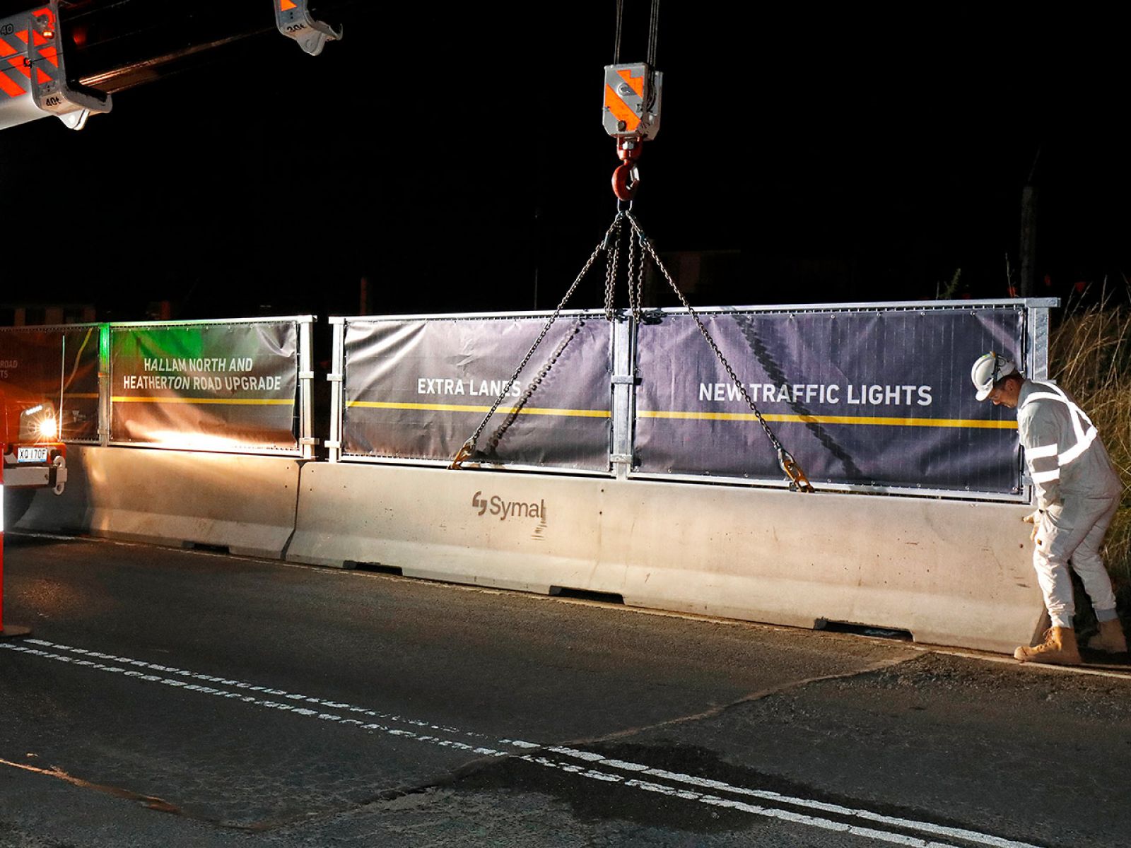 New safety barrier being lowered onto Hallam North Road at night