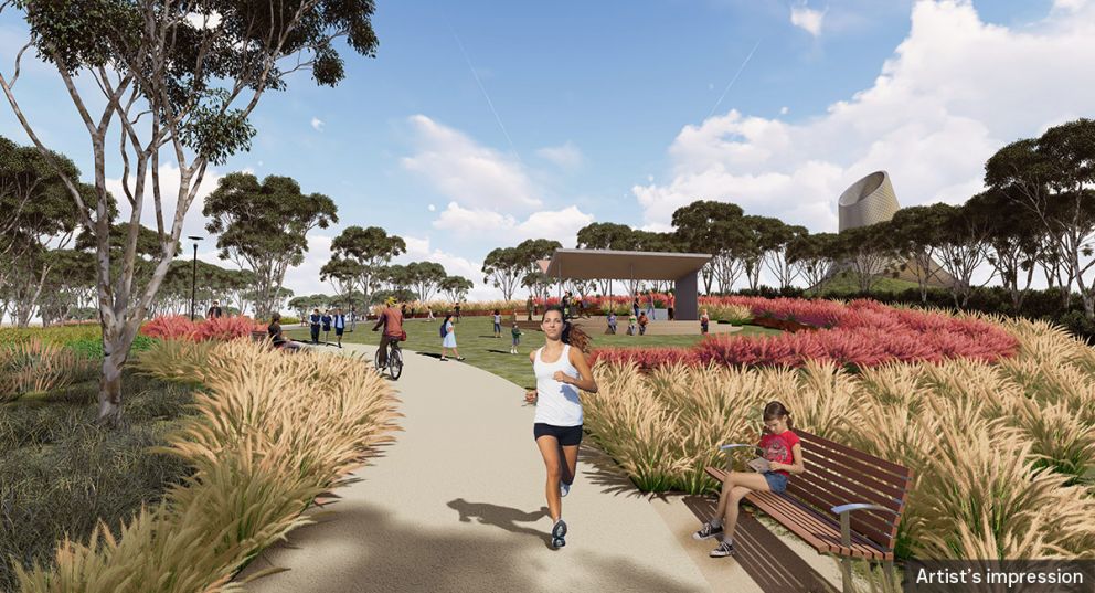 An artist impression ground level view of recreational park users on the Yarra Link green bridge and showing the southern portal ventilation structure in the background.