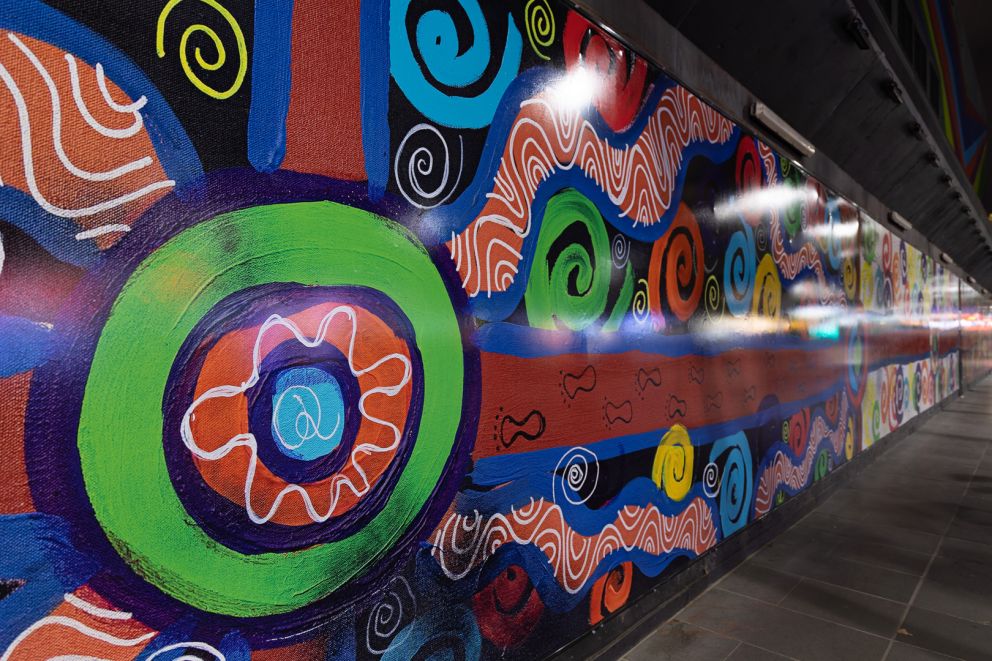 Colourful Indigenous artwork on temporary construction walls