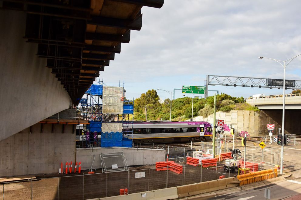 A V/Line train travels safely under the new road bridge at the Fitzgerald Road level crossing.