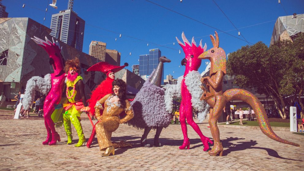 The Huxleys and performers pose for a photo in Federation Square