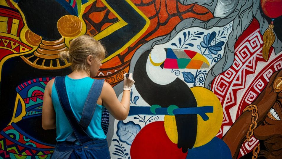Young person painting mural