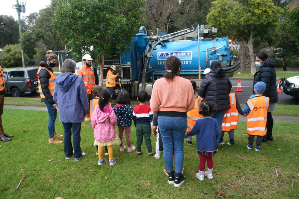 The kids and teachers look up close at the vacuum truck
