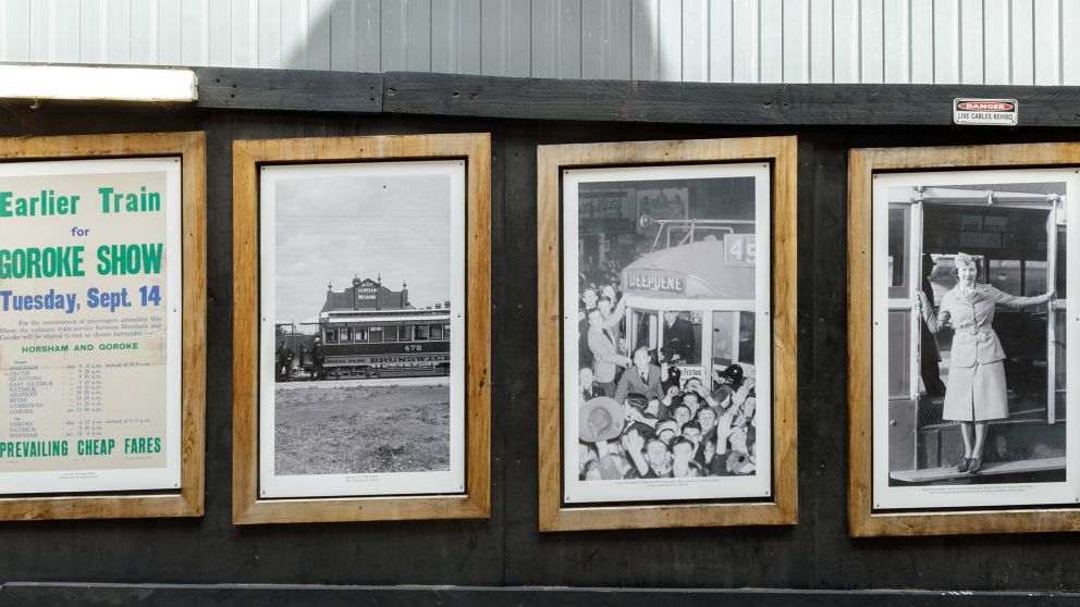 Old photographs on display in wooden frames