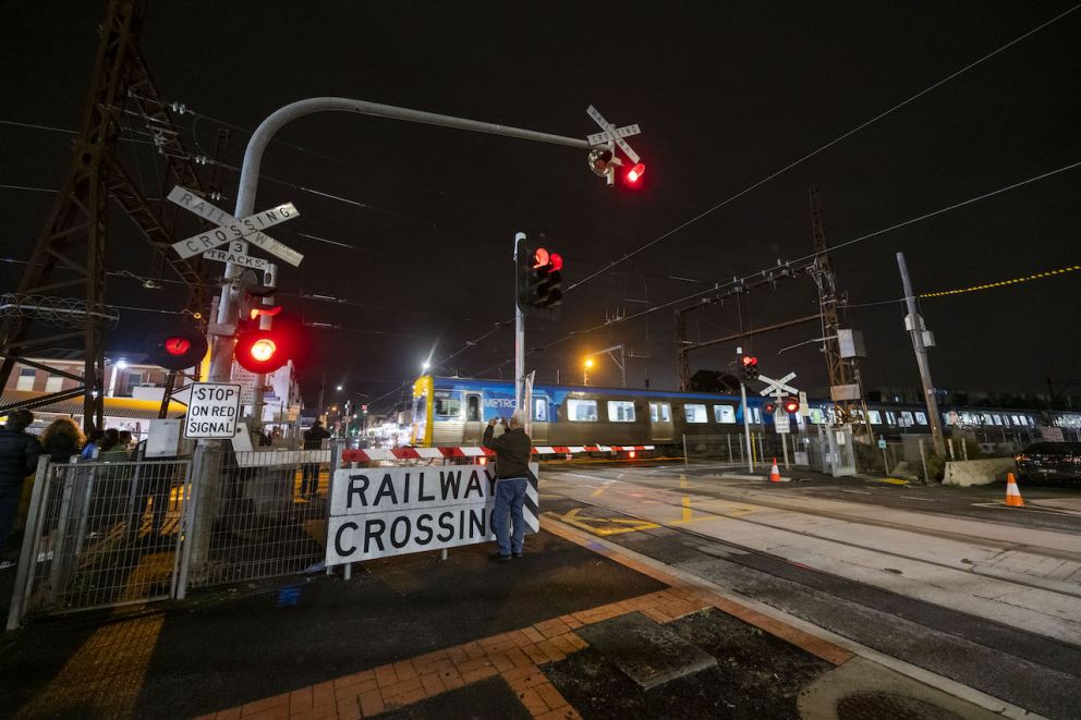 Final train to stop at Glenhuntly Station passes through the level crossing at Glen Huntly Road