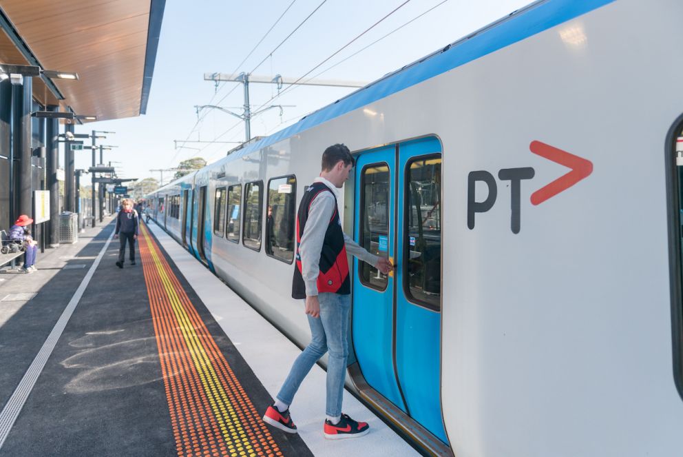 Passengers board a train at the newly opened Greensborough Station