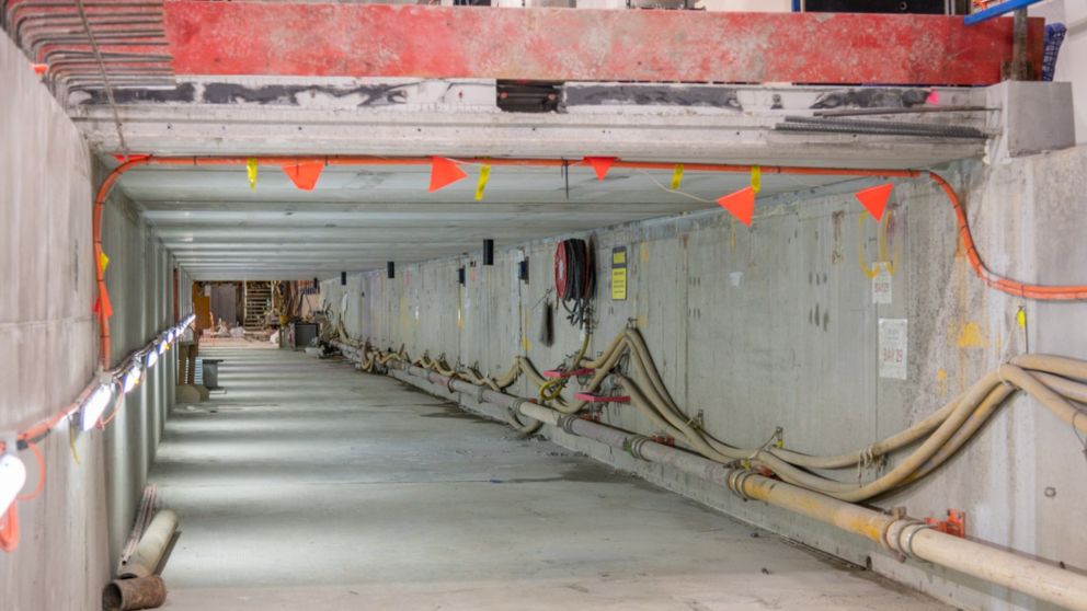 A rectangular concrete walkway with wiring lining the walls.