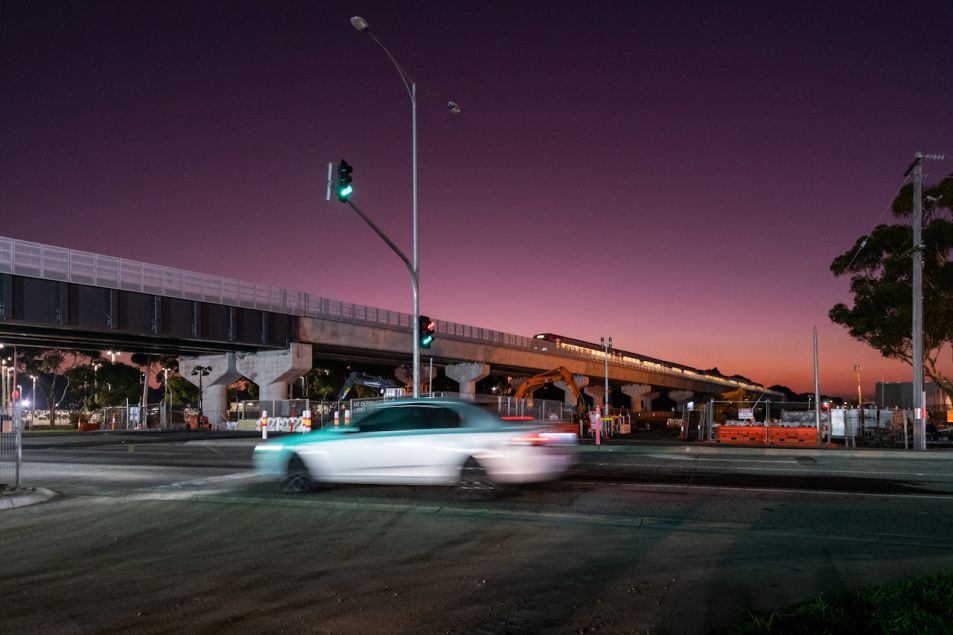 Cars passing under the elevated rail and through the new level crossing free Mt Derrimut Road