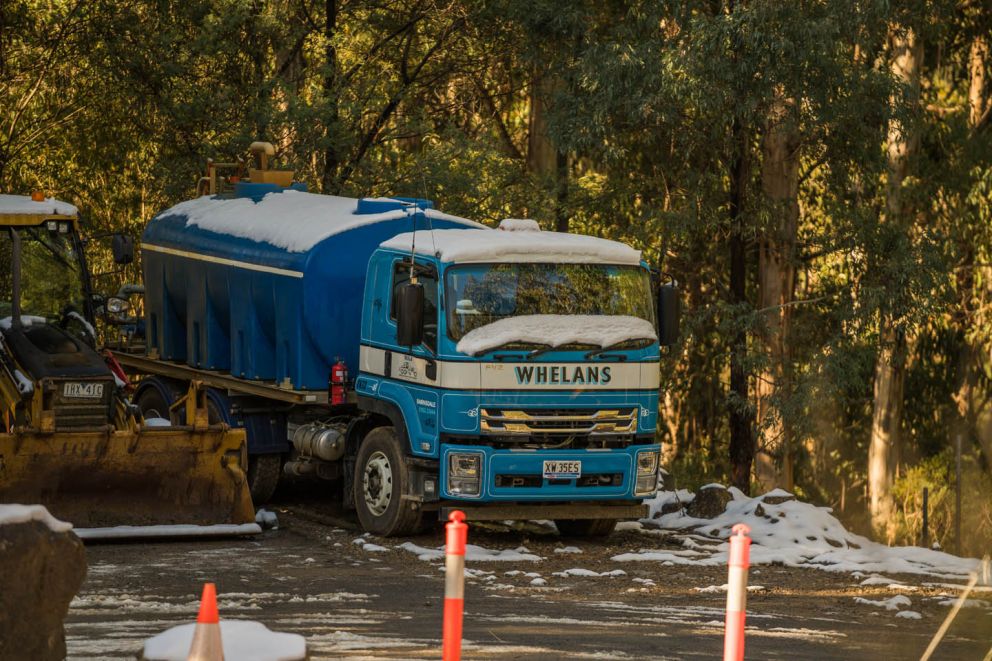 Water truck covered in snow