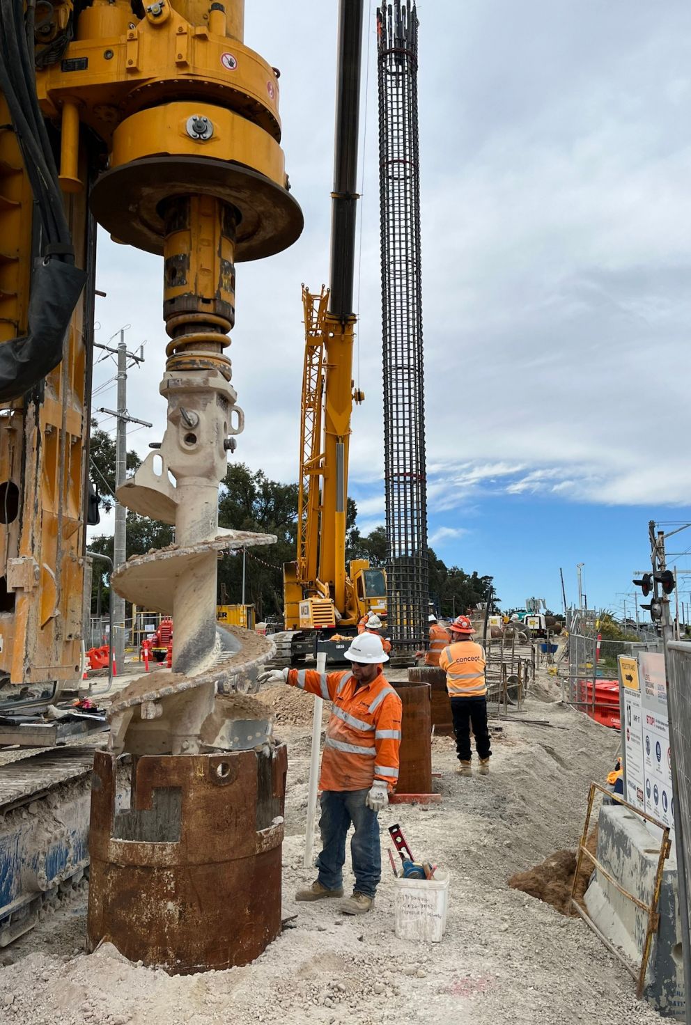 Workers piling on site as the steel foundations are lifted into place