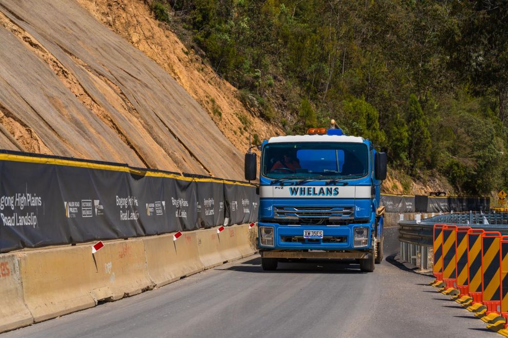 A water truck watering down the road to stop dust