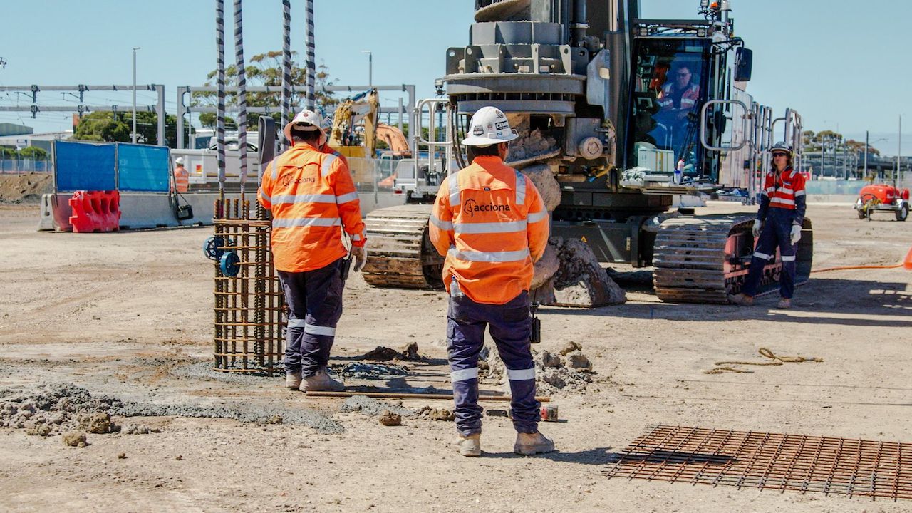 Workers on site supervising the piling works
