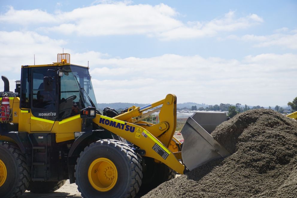 A wheel loader works to move material around site