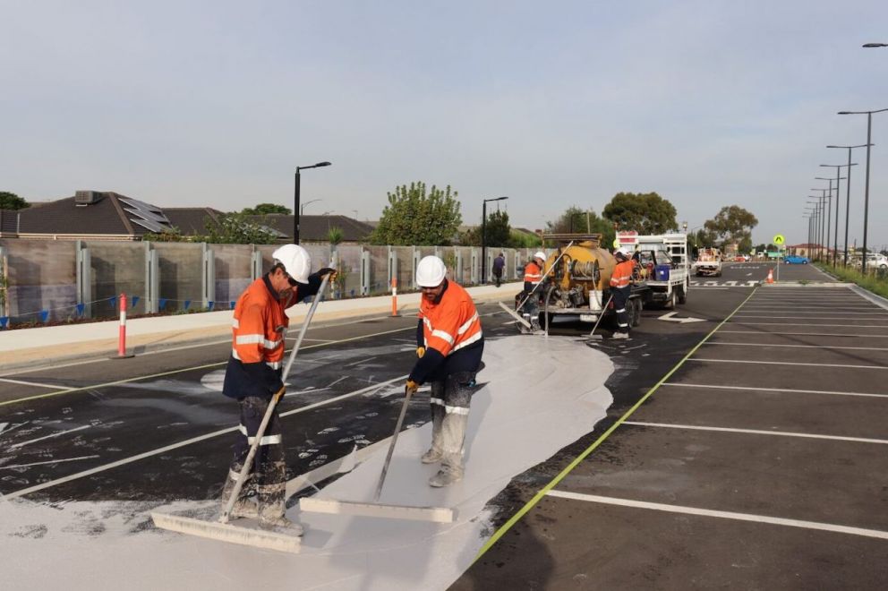 Workers applying CoolSeal to car park