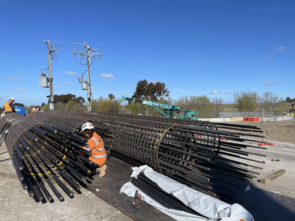 Worker prepares the piling rig cages to be dropped into the ground