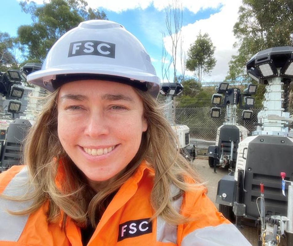 Construction woman with robots in background