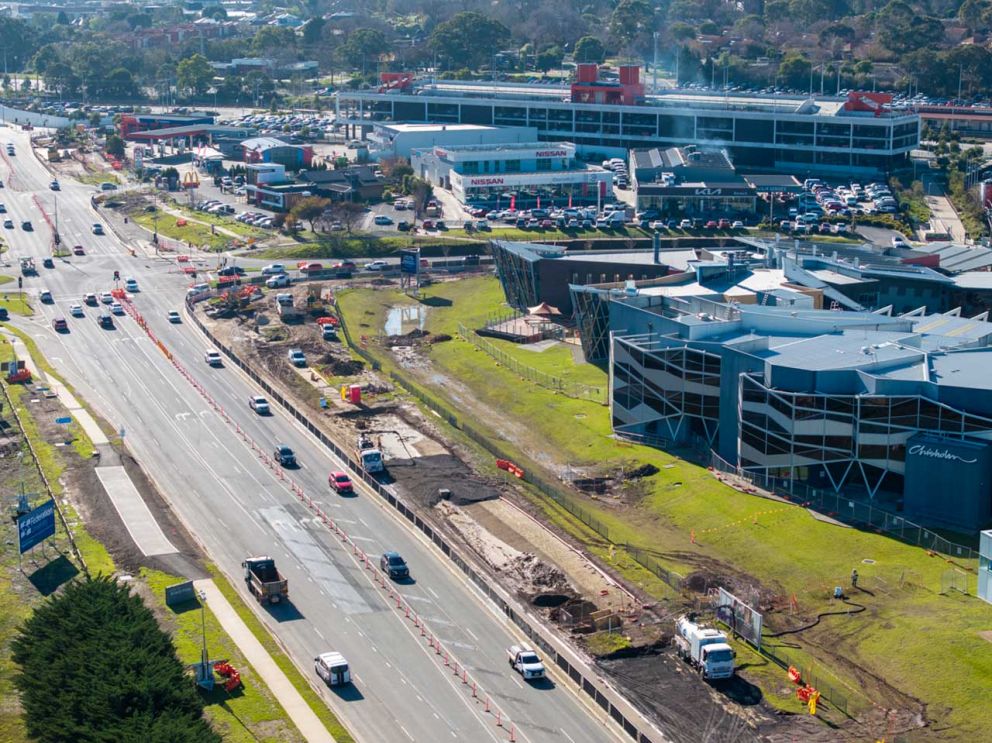 Crews work behind barriers to build an additional southbound lane on Clyde Road